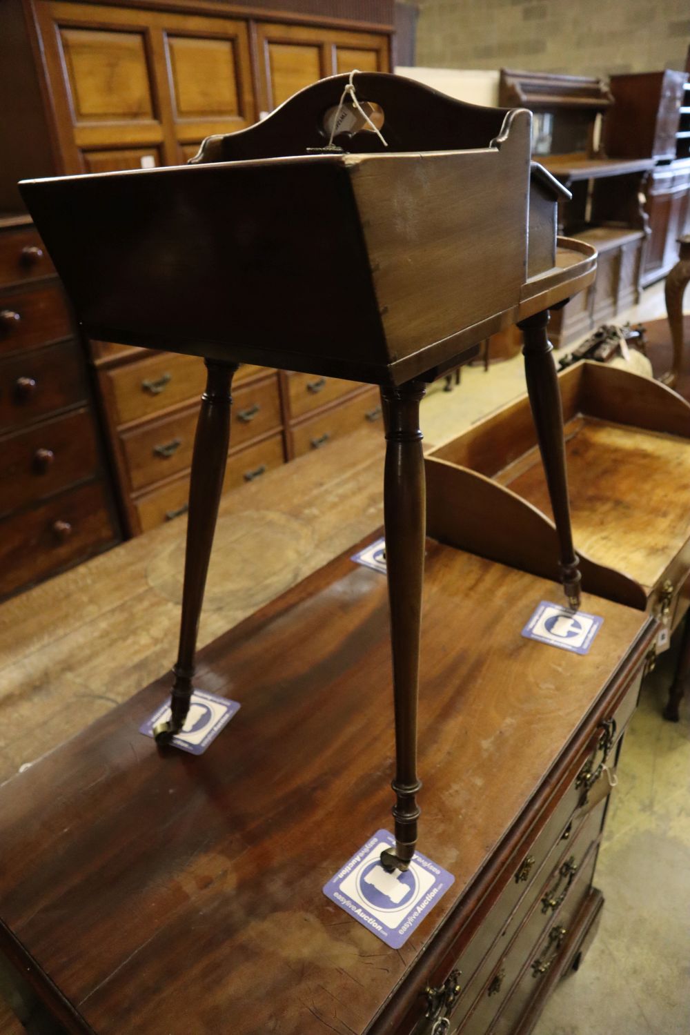 A Victorian mahogany sewing table on slender splayed baluster legs with brass caps and castors, width 54cm depth 33cm height 70cm